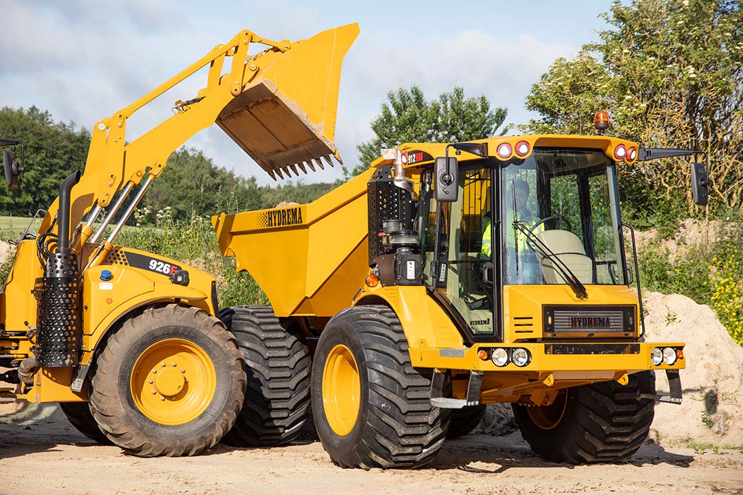 912G HM Getting Loaded By Hydr Backhoe Golf